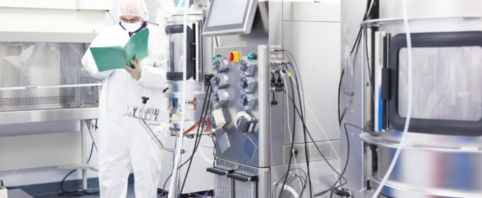 Scientist with clipboard in a biotechnology lab.