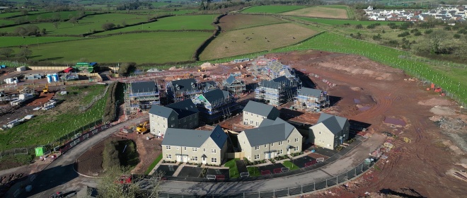 A housing construction site, surrounded by rural countryside