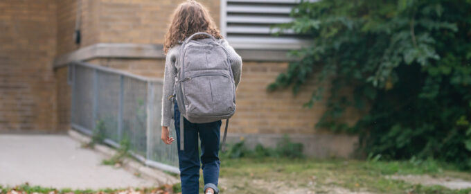 School absence article image, young girl wit a backpack