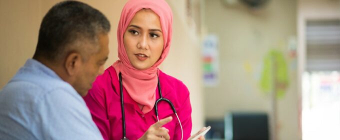 Image of a healthcare professional showing a patient something on a smartphone