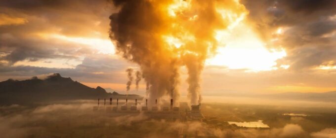 Image of factory pollution against a sun set.