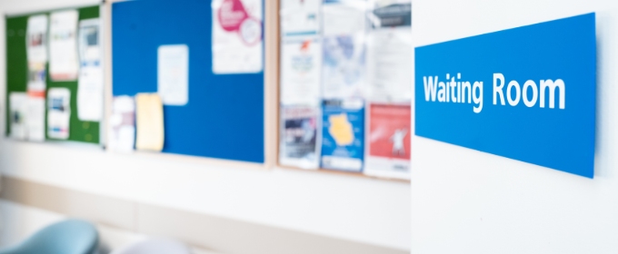 A sign pointing to a waiting room in an NHS General Practice.