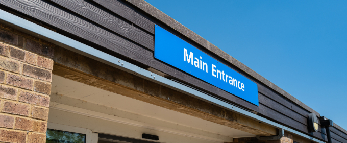 An exterior view of the main entrance to a GP surgery in England.