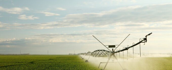 A farmers field being irrigated with a centre pivot sprinkler system